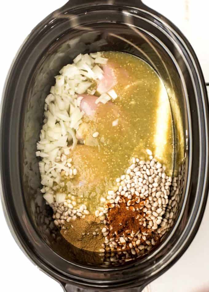white chicken chili ingredients in slow cooker