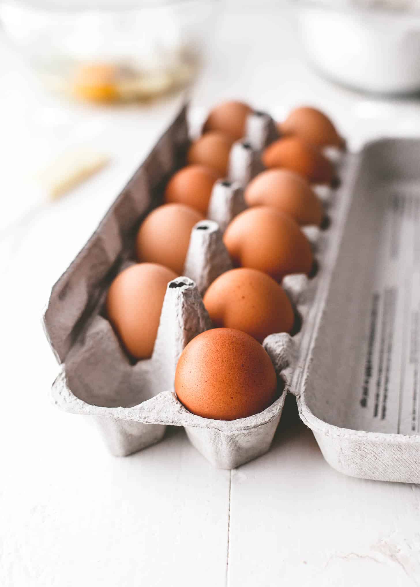 eggs in an egg crate on a white table