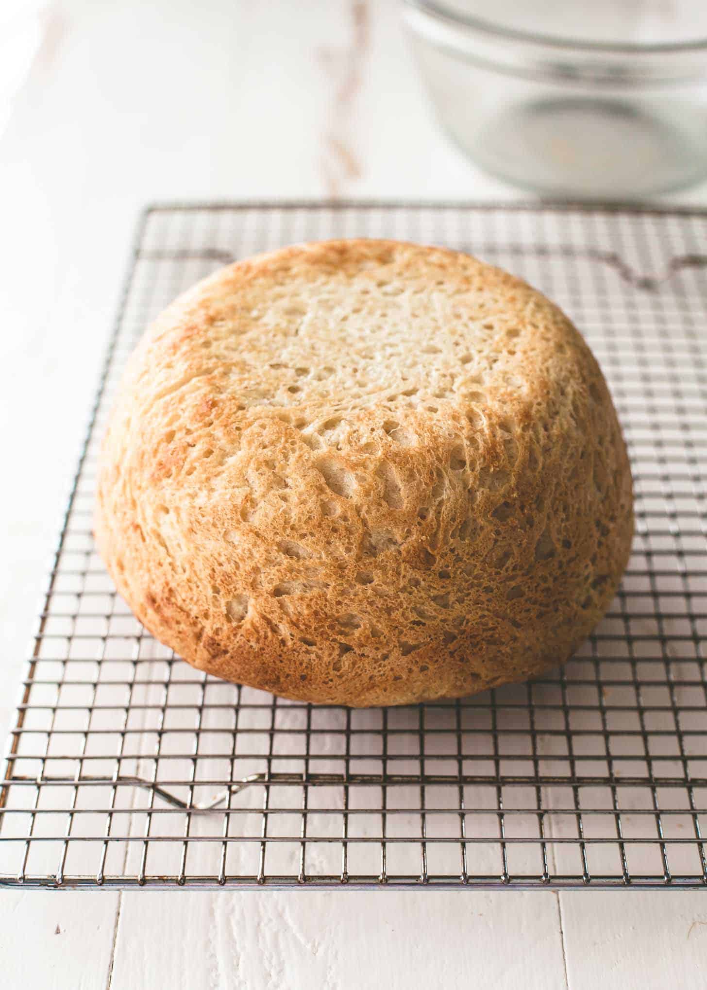  a round loaf of no knead everyday bread on a cooling rack