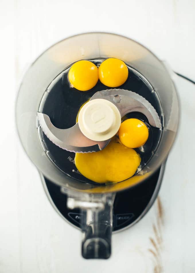 egg yolks in the bowl of a food processor