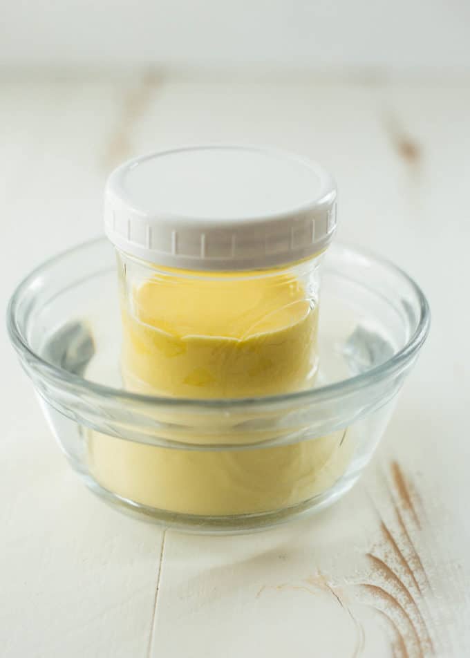Blender Hollandaise in glass jar cooling in a water bath