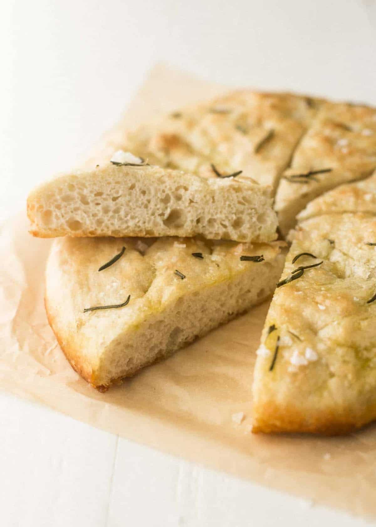 No Knead Focaccia, sliced, on parchment paper