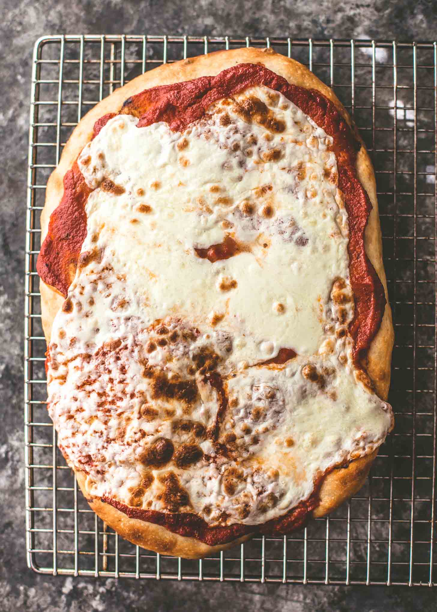 no knead sheet pan pizza on a cooling rack