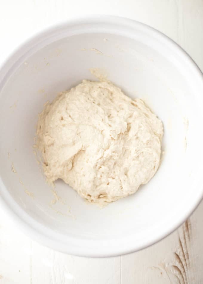 pizza dough in a white bowl before rising