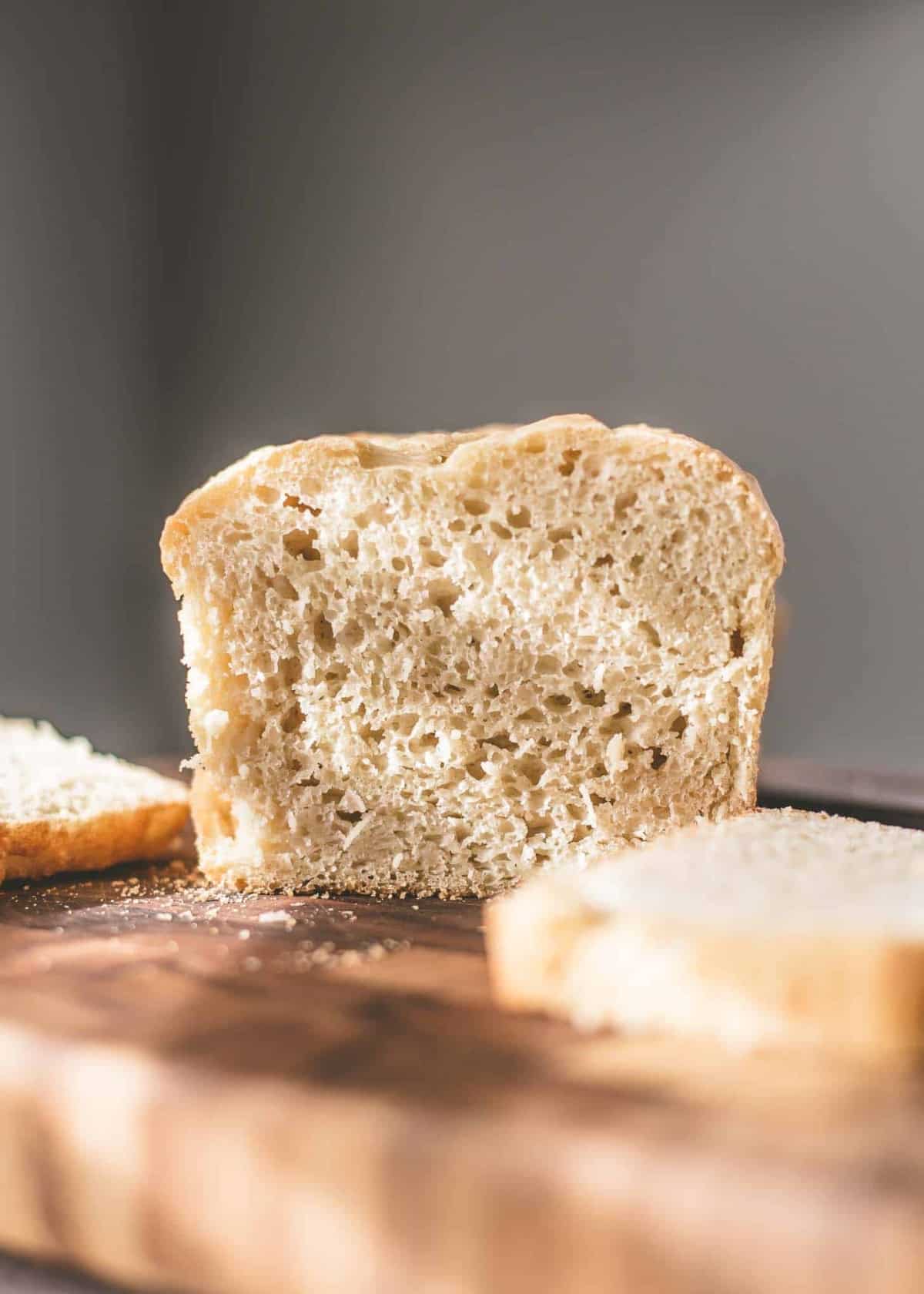 No Knead Sandwich Bread, sliced, on a wooden cutting board