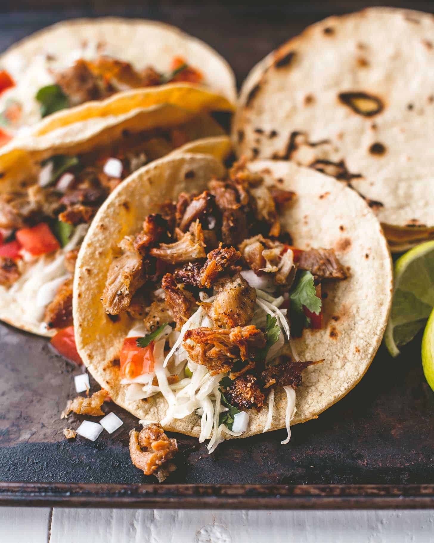 overhead image of chicken carnitas tacos with toppings