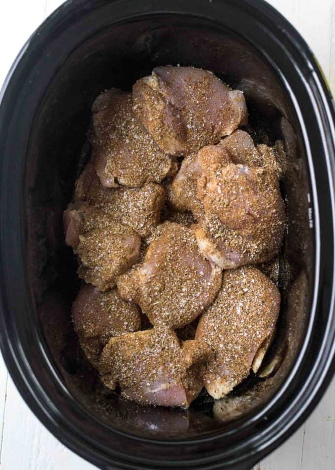 chicken covered in spices in the slow cooker