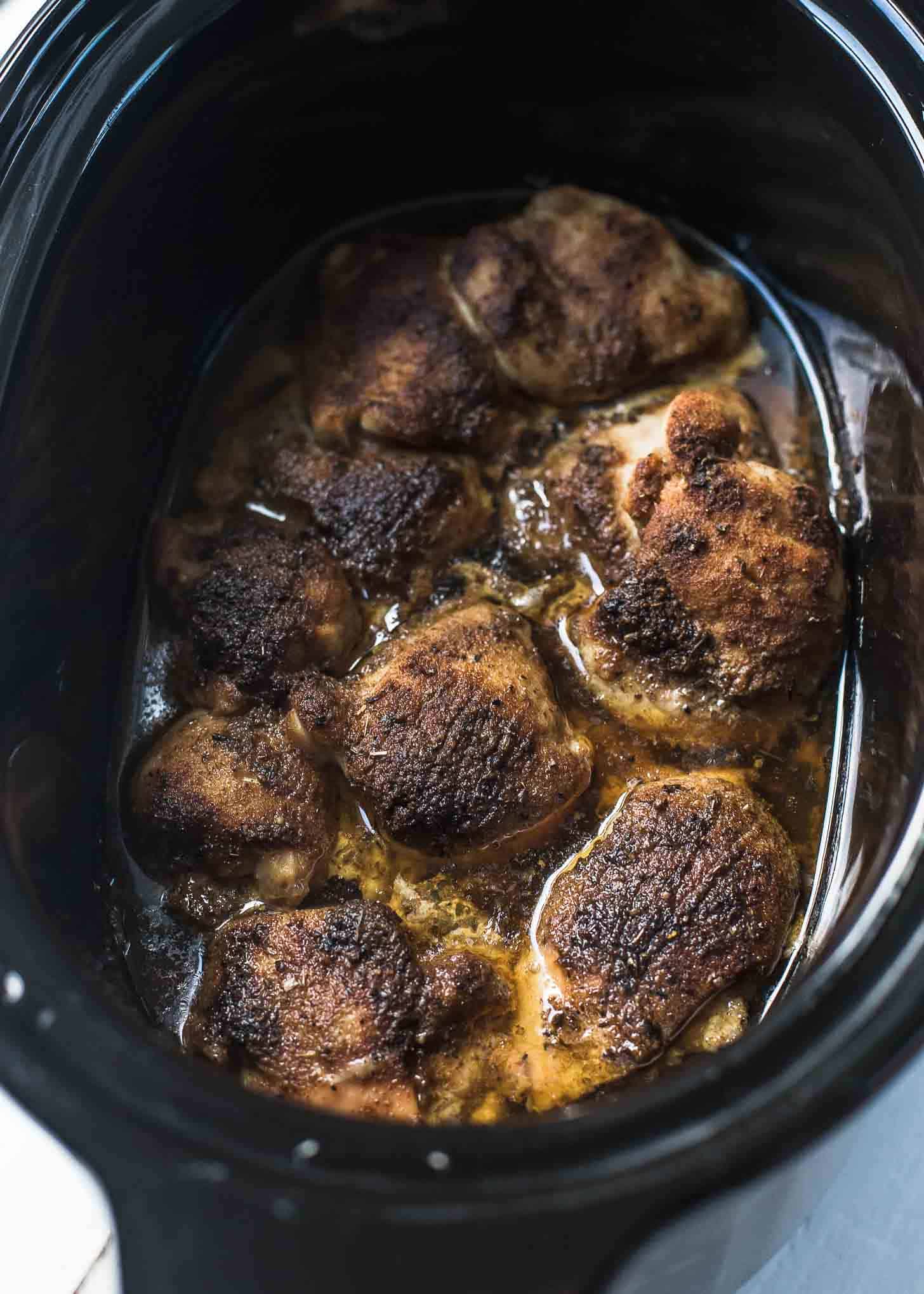 overhead image of cooked chicken in the slow cooker