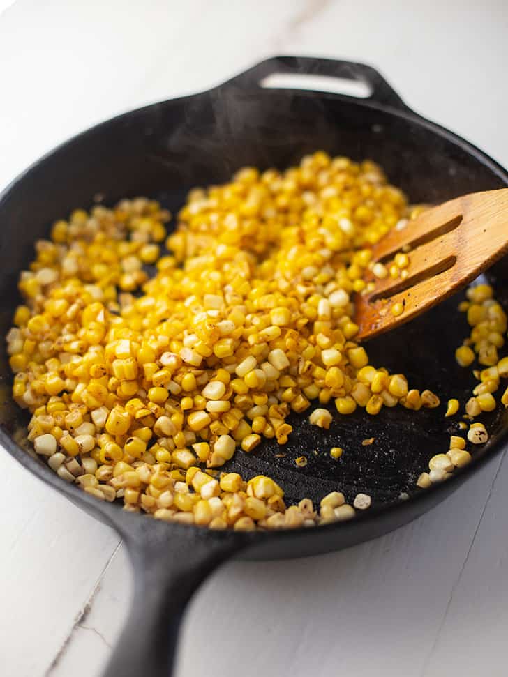sauteeing corn in a cast iron skillet