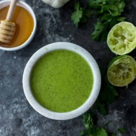 Cilantro Lime Vinaigrette in a small white bowl on a grey table