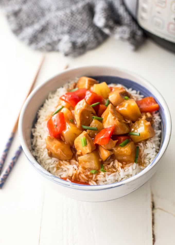 instant pot sweet and sour chicken over rice in a white bowl