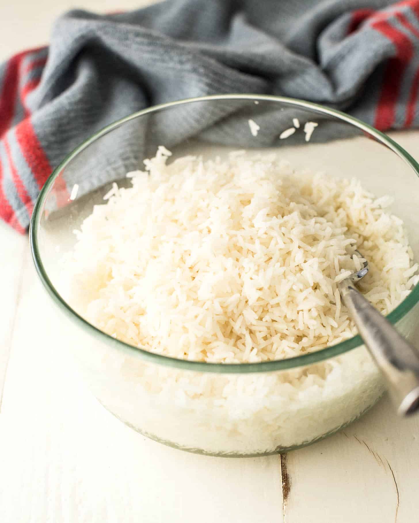 rice in a clear bowl with a spoon