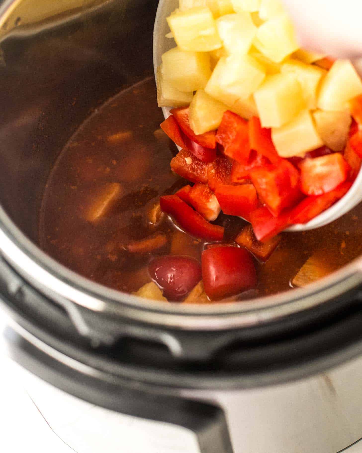 adding ingredients to the bowl of the instant pot