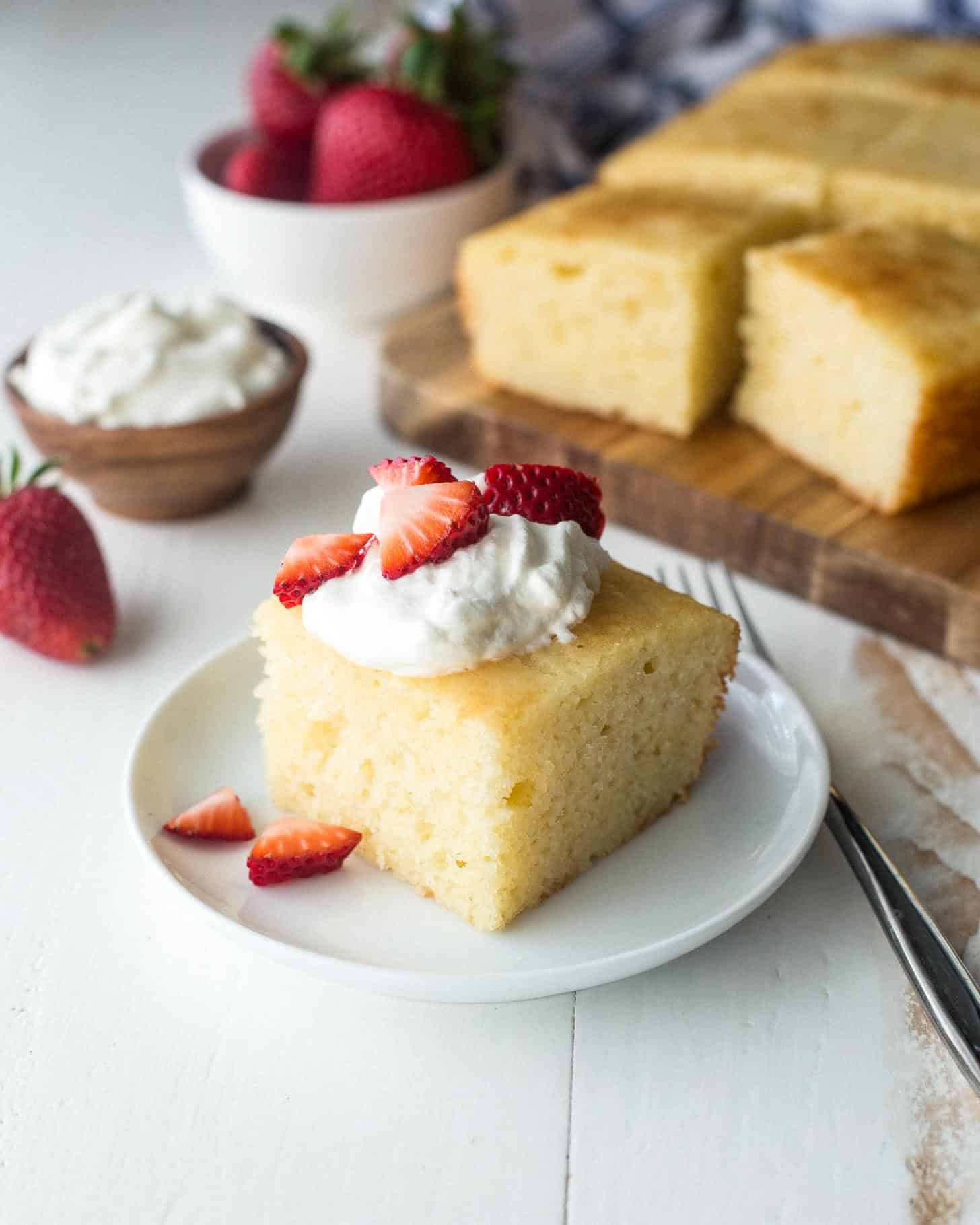 semolina yogurt cake topped with whipped cream and berries