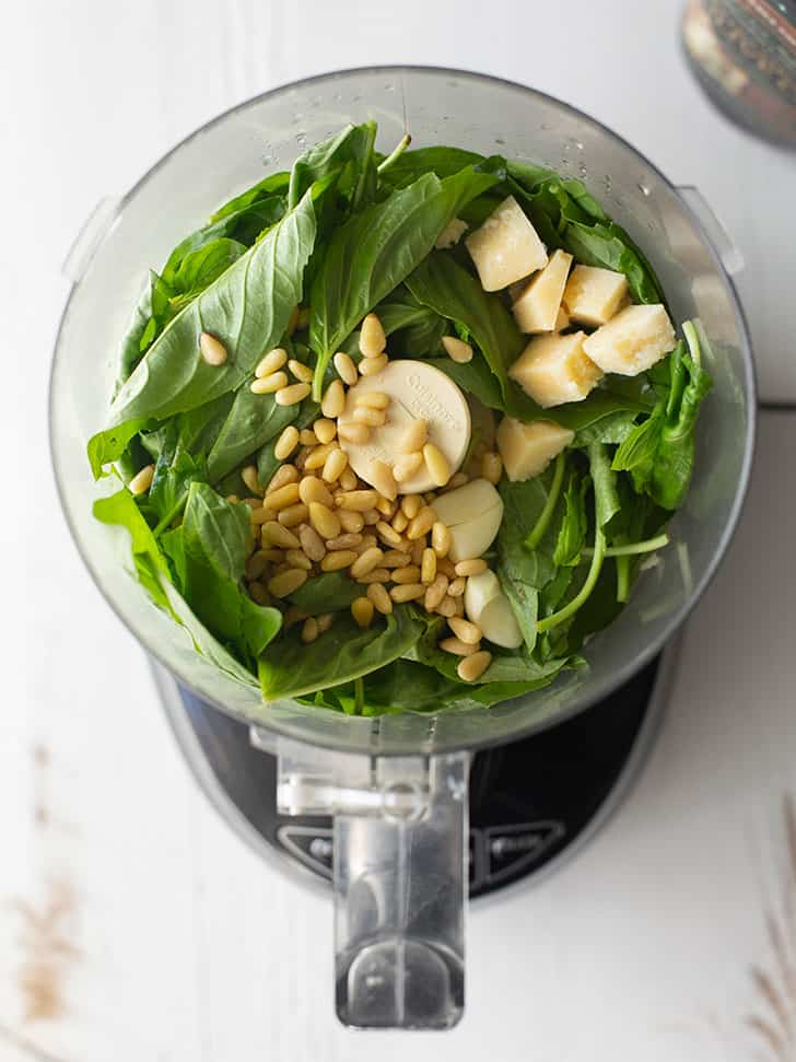 basil, pine nuts, parmesan cheese and garlic in a food processor