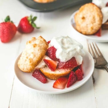 Muffin Pan Strawberry Shortcake topped with whipped cream on a white table