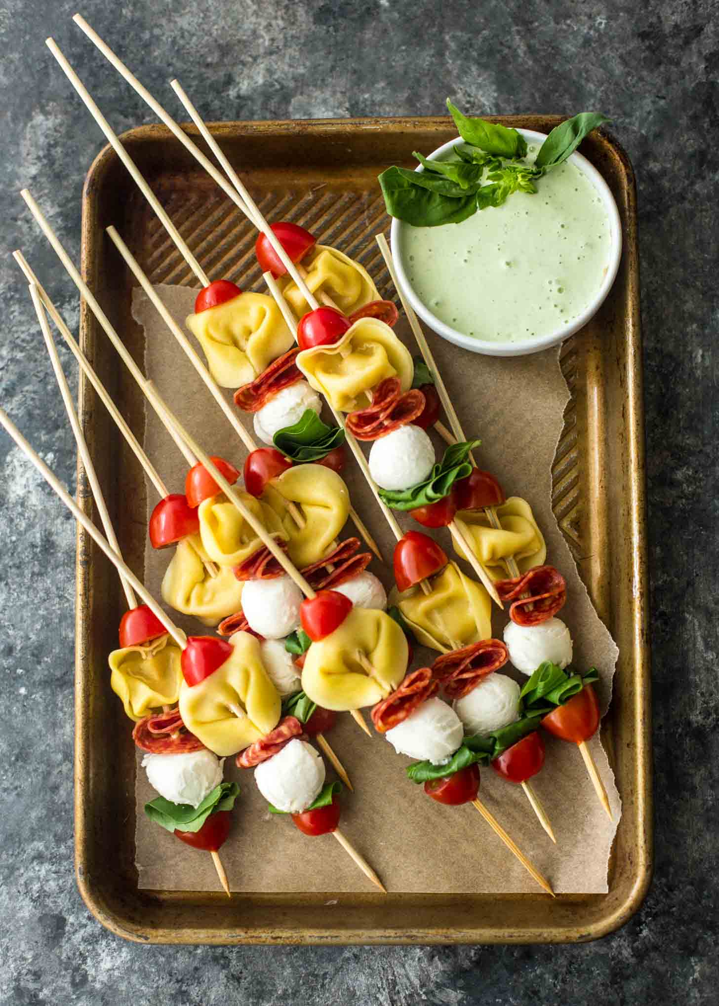 Pasta Salad Skewers on a parchment lined sheet pan