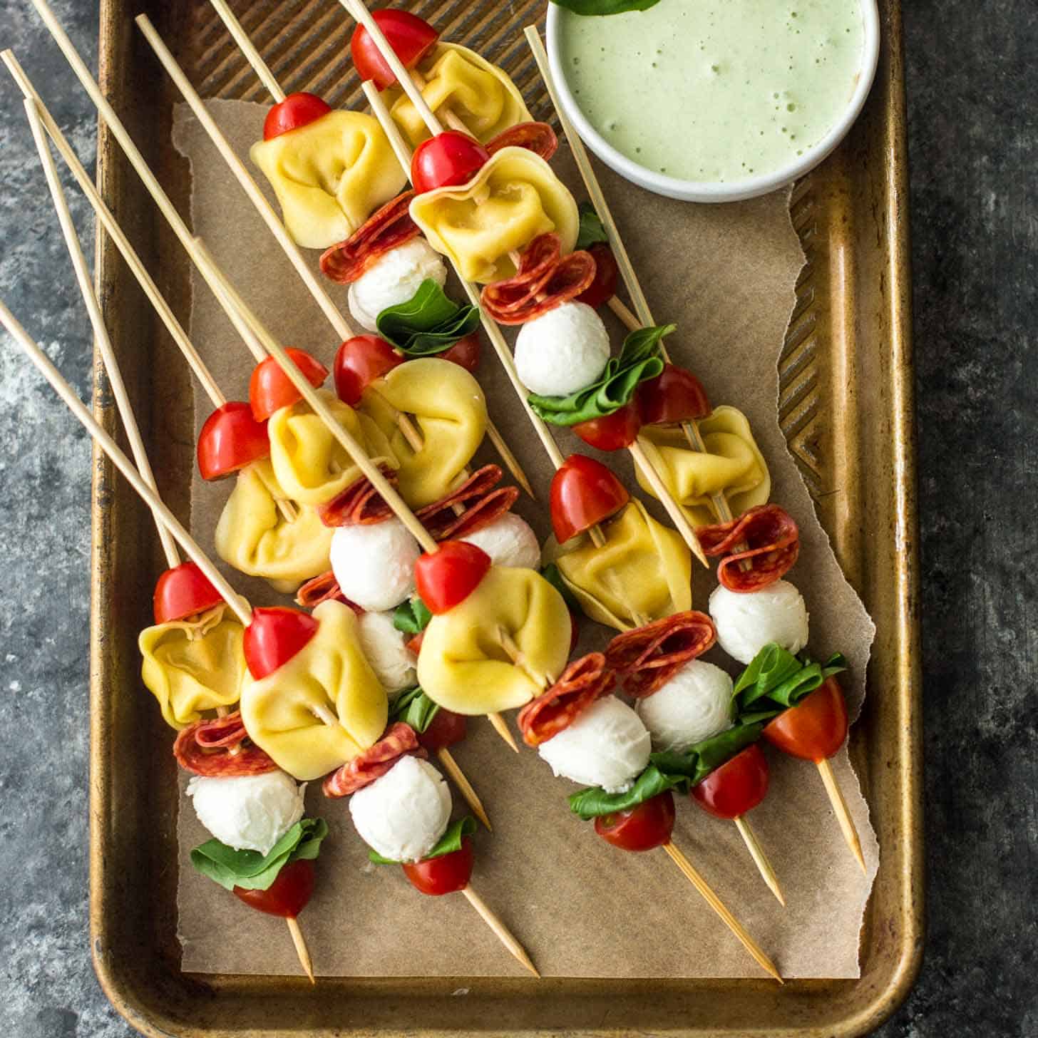Pasta Salad Skewers on a parchment lined sheet pan