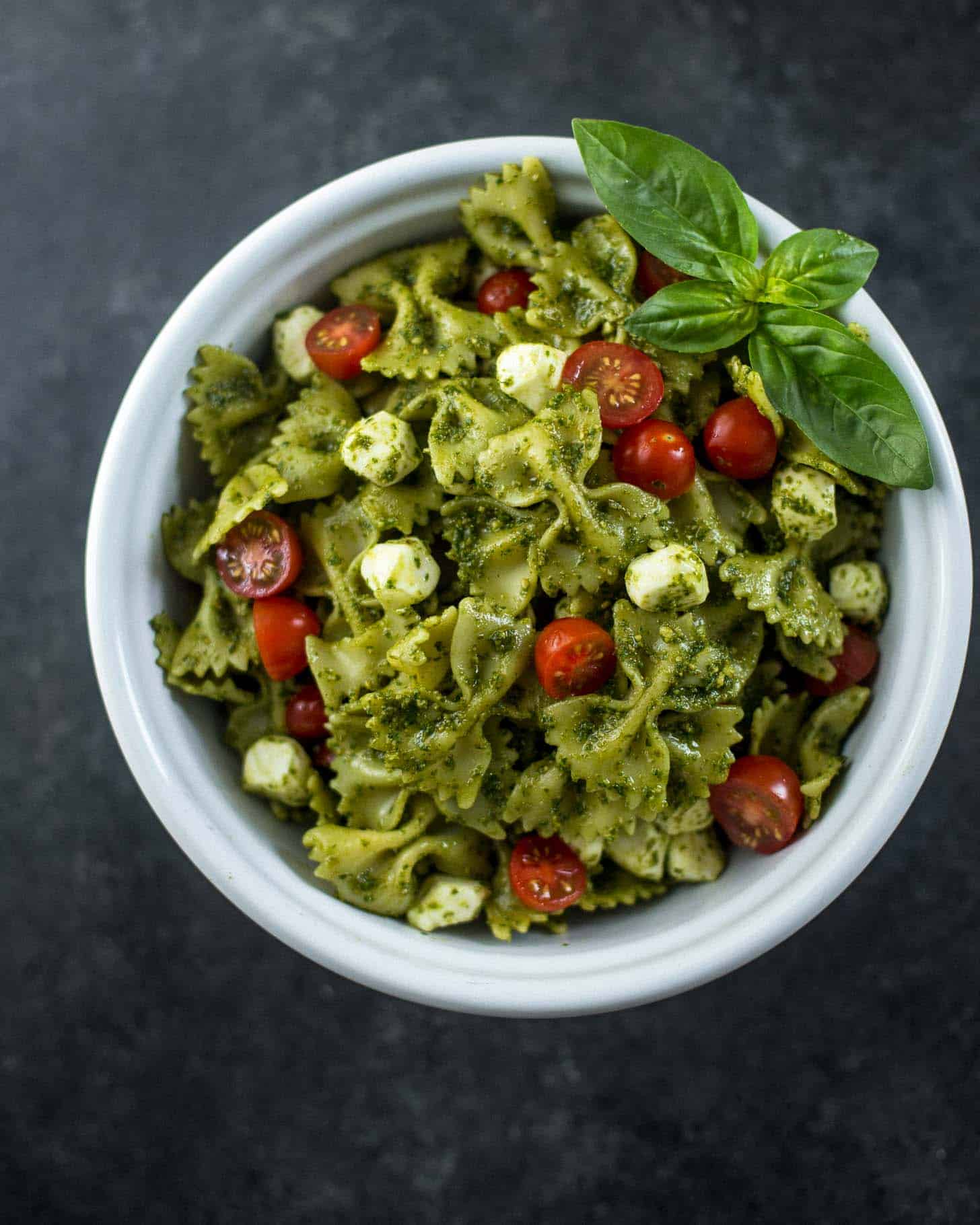 overhead image of Pesto Pasta Salad in a white bowl