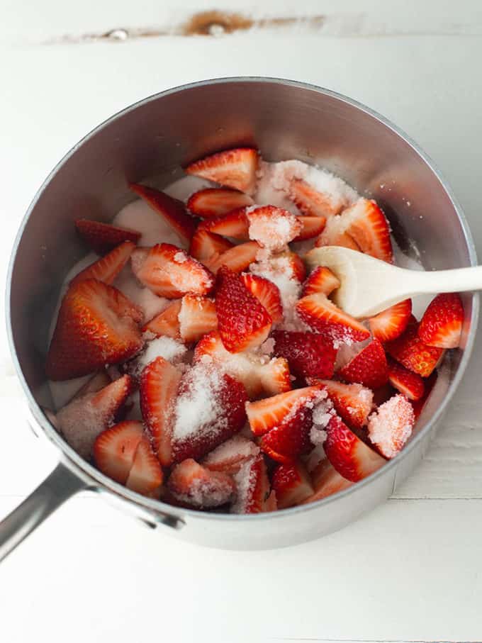 cut strawberries and sugar in a saucepan