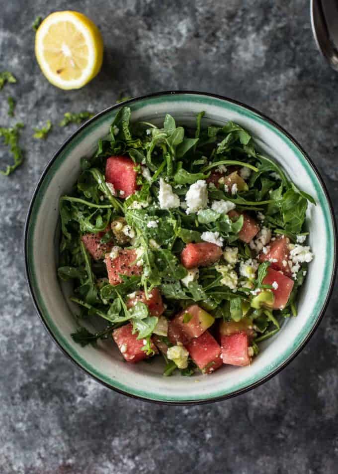 Watermelon, feta and arugula salad in a blue and white bowl