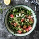 watermelon, feta and arugula salad in a blue and white bowl