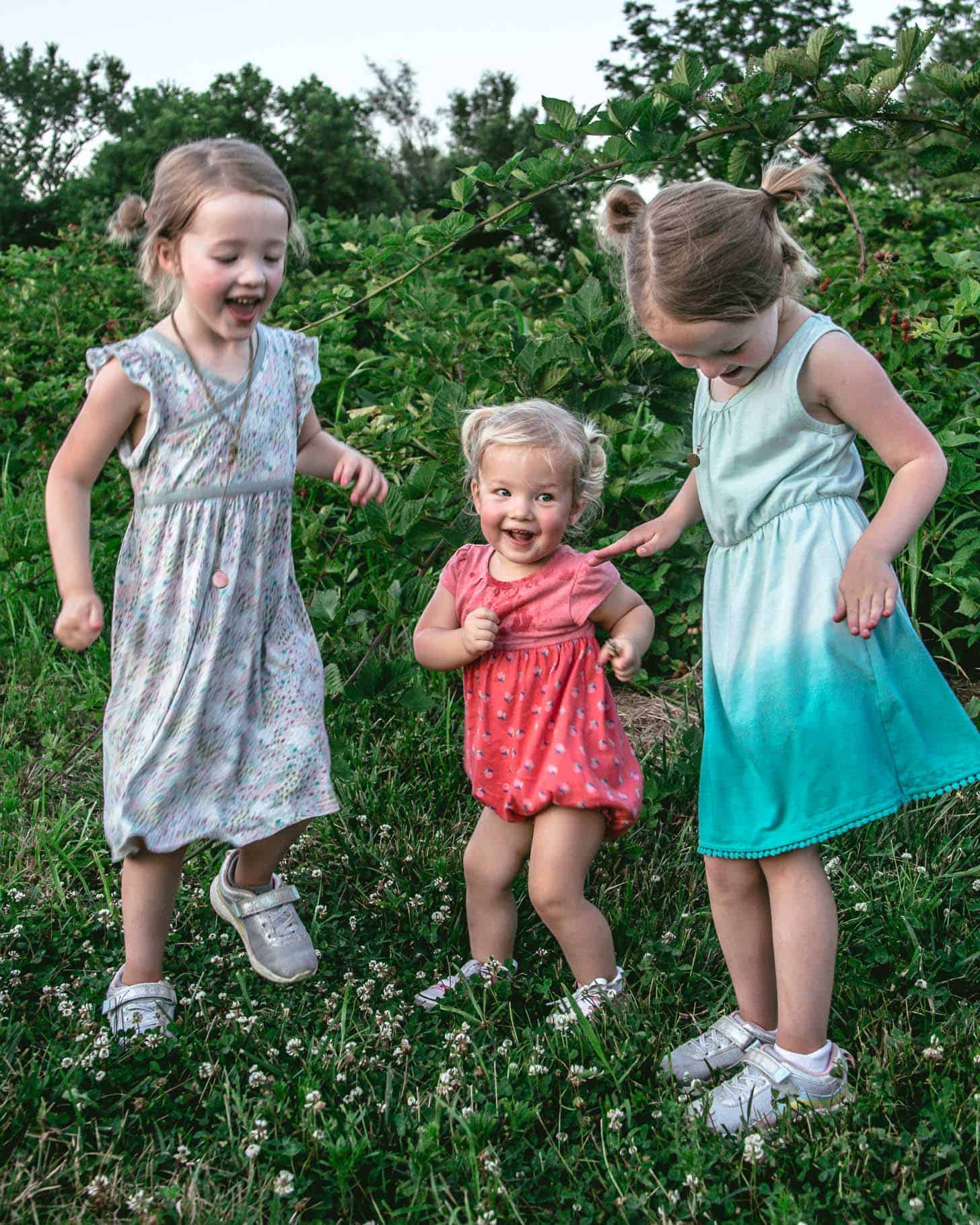 3 young girls dancing in the blackberry field