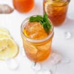 bourbon sweet tea cocktail in a mason jar with crushed ice around it