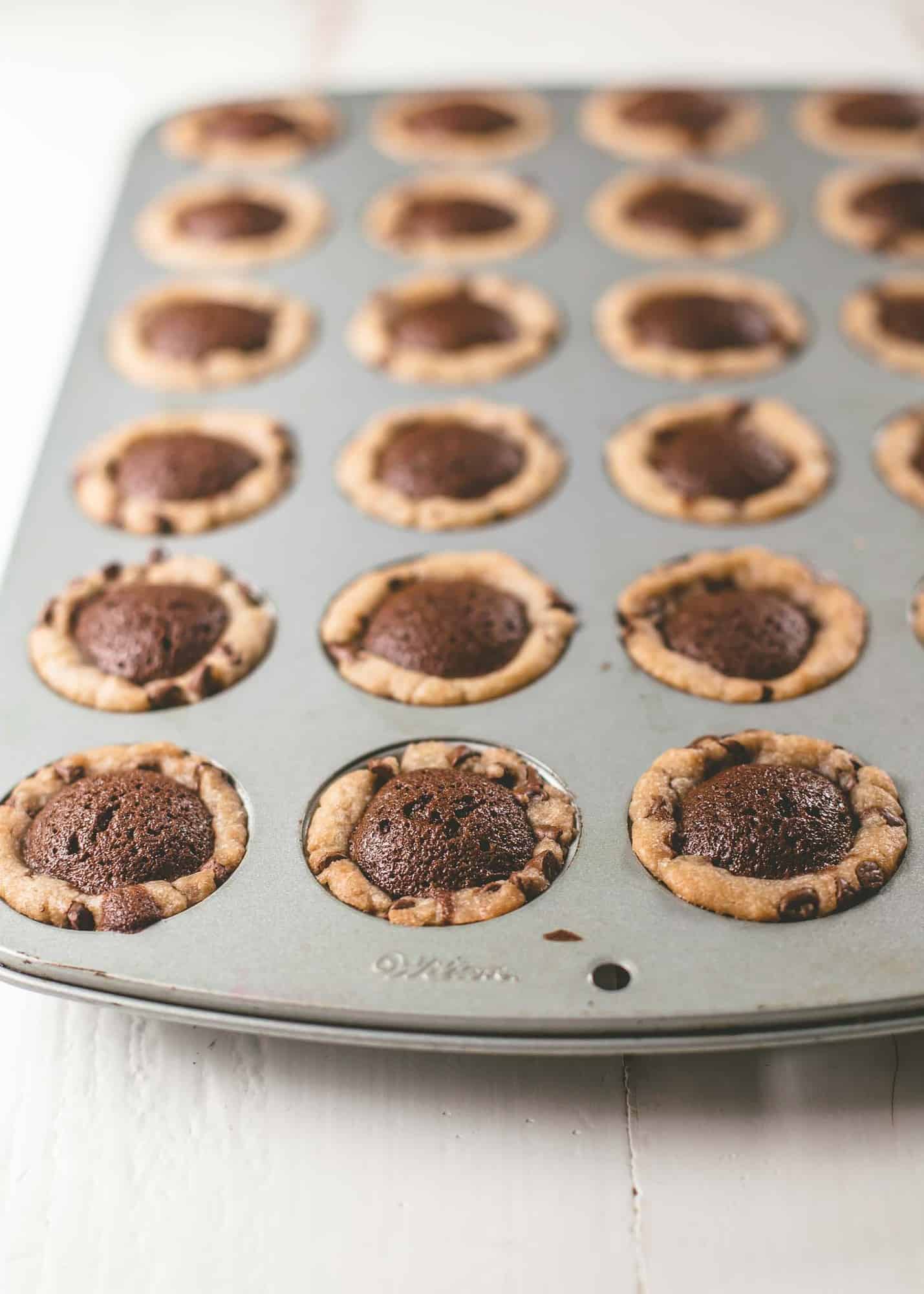 chocolate chip brownie tarts in a muffin tin