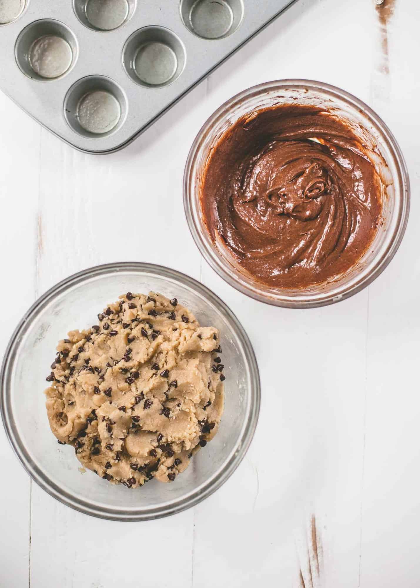 overhead image of chocolate chip cookie dough and brownie mix in clear bowls
