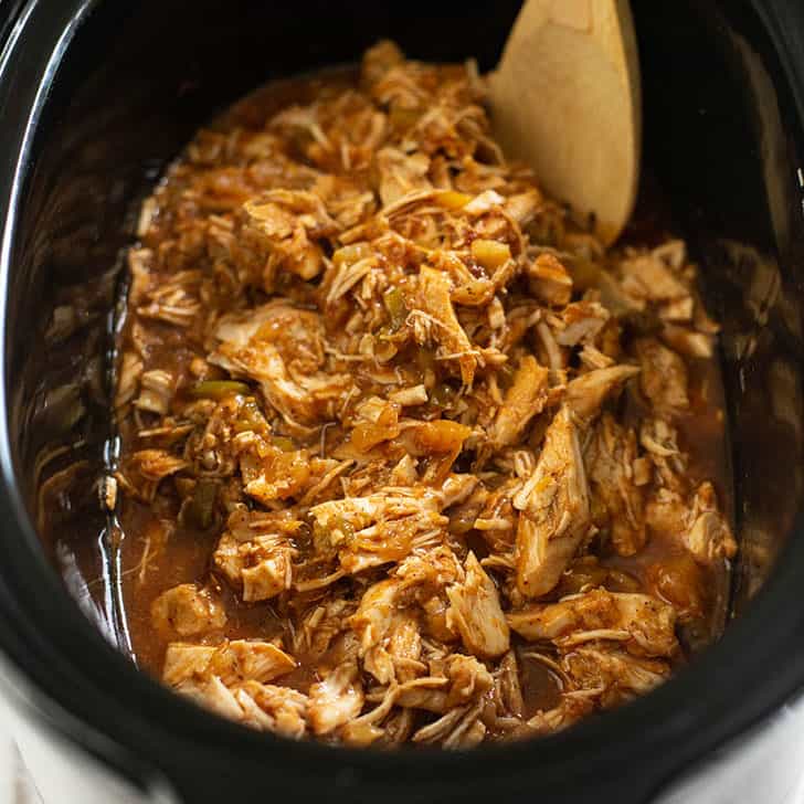 overhead image of shredded hawaiian chicken in the slow cooker