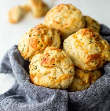 cheddar drop biscuits in a towel lined basket