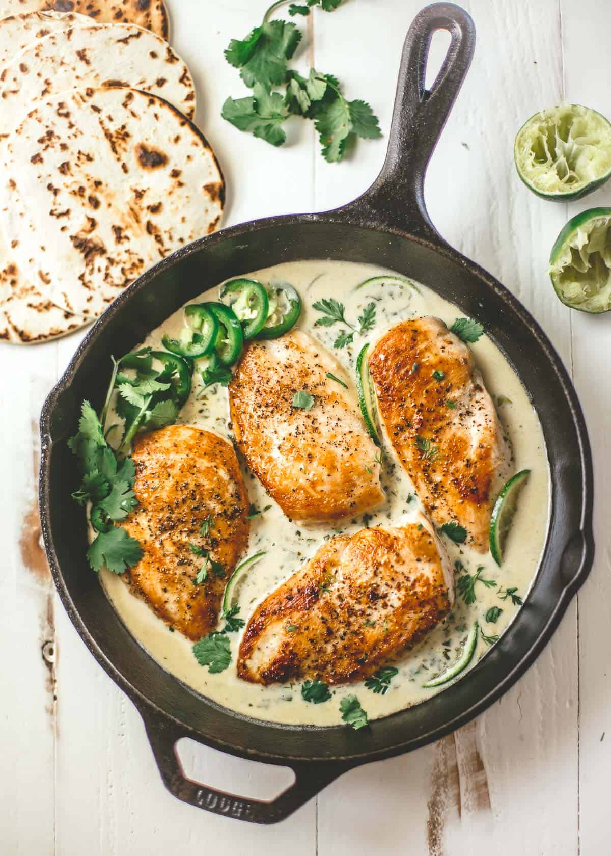 chicken with cilantro lime sauce in a cast iron skillet