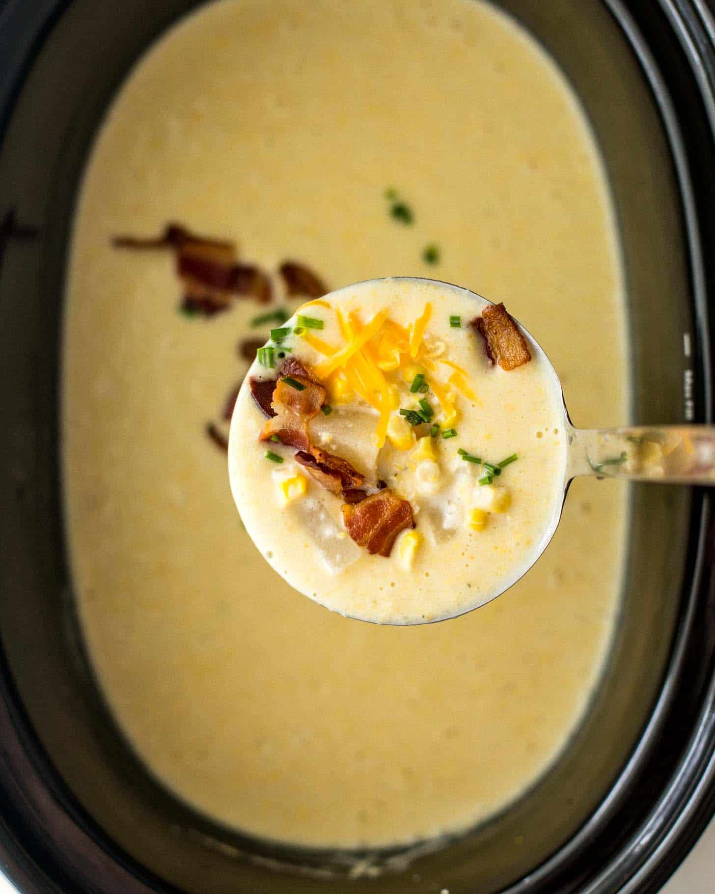 a spoonful of soup above the slow cooker