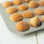 apple cider donut mini muffins in a muffin tin