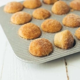 apple cider donut mini muffins in a muffin tin