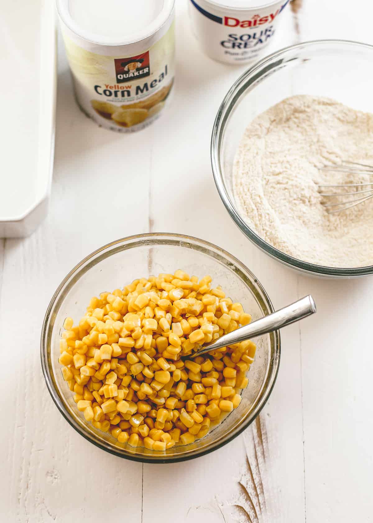 overhead image of corn kernels in a clear glass mixing bowl