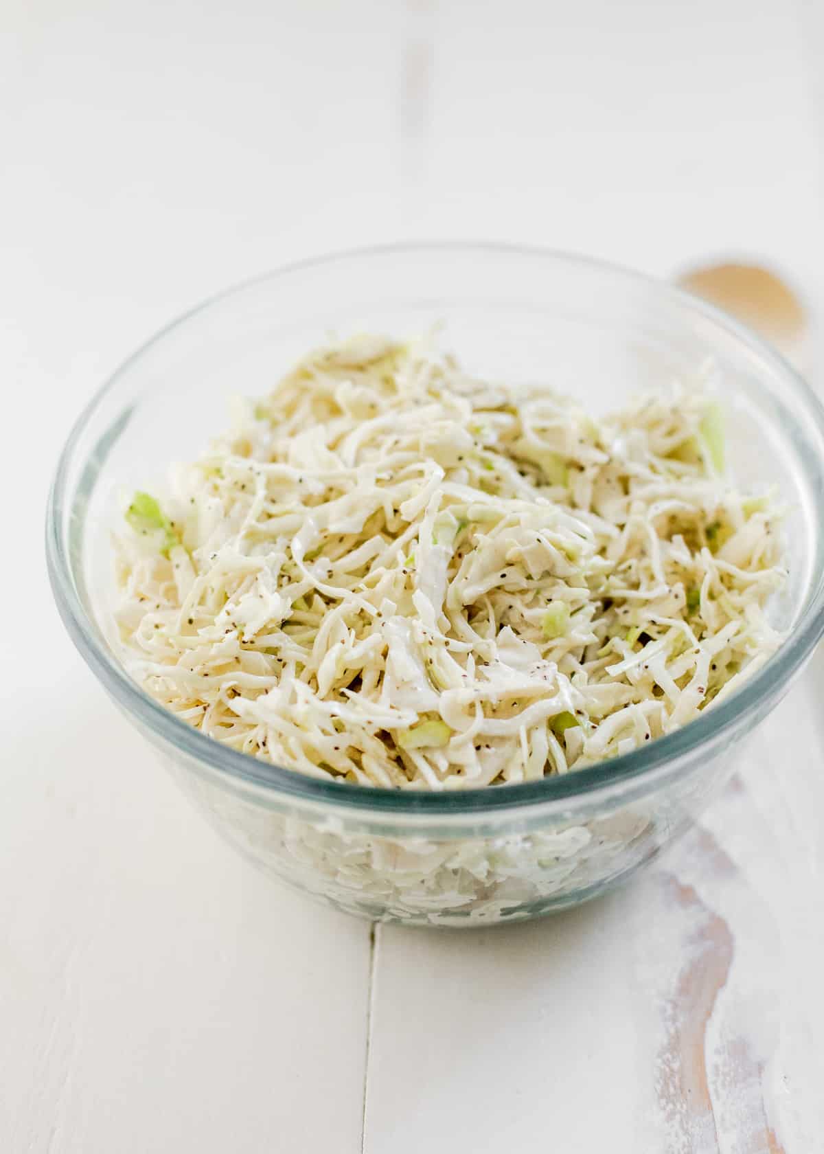 glass bowl of coleslaw with green cabbage