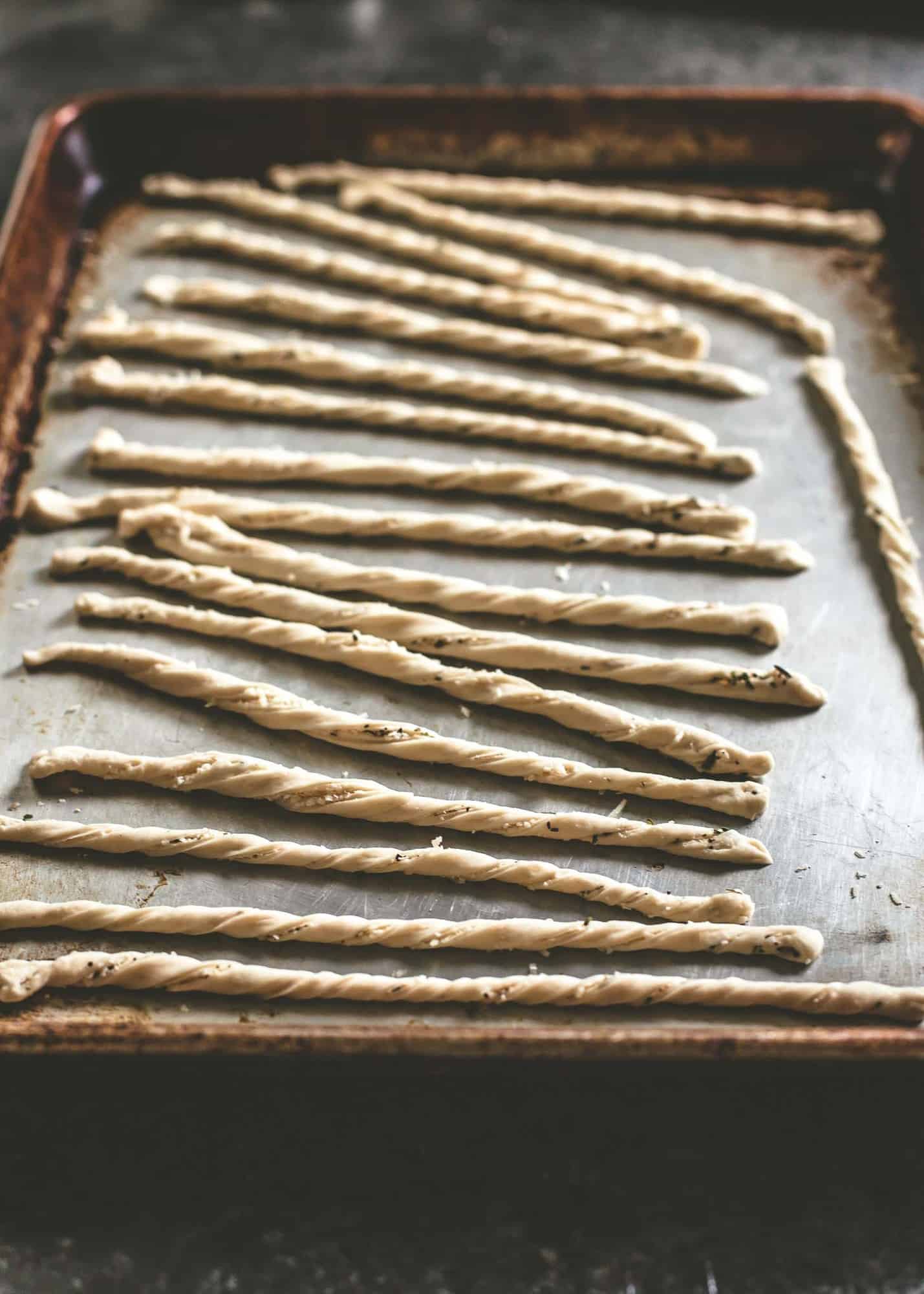 uncooked breadsticks on a sheet pan