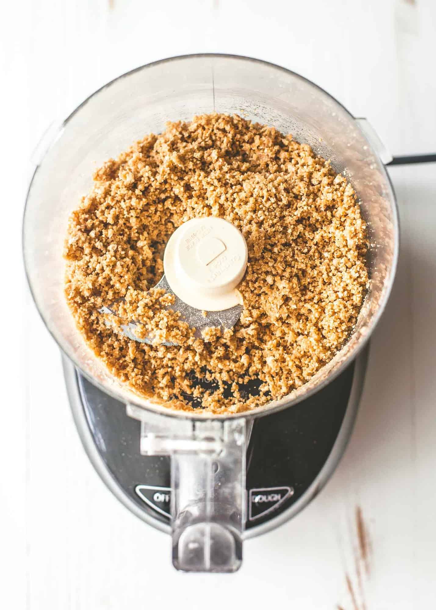 overhead image of graham cracker crumbs in a food processor