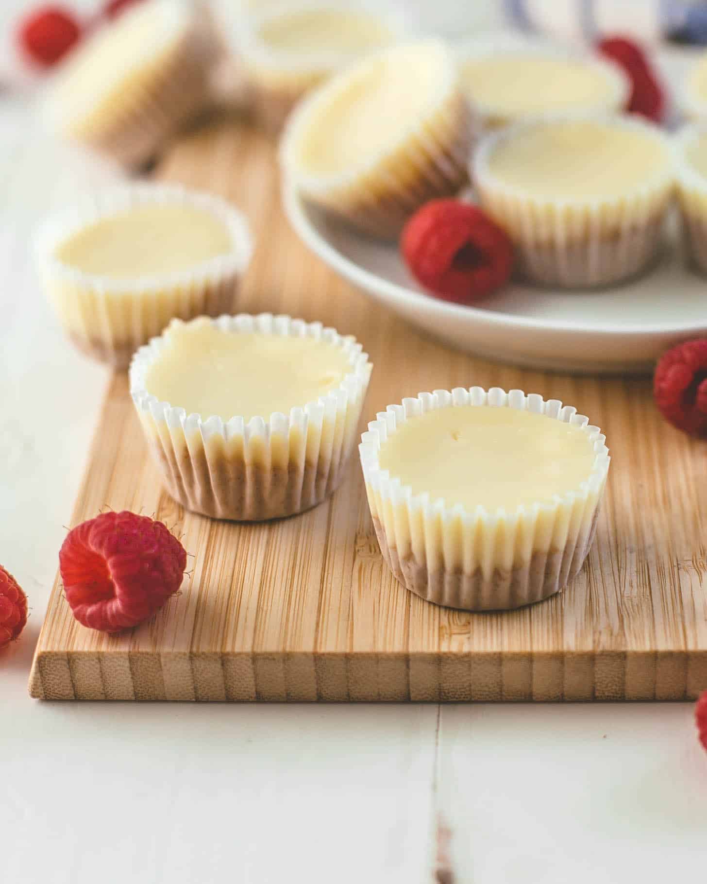 mini cheesecakes on a wood cutting board