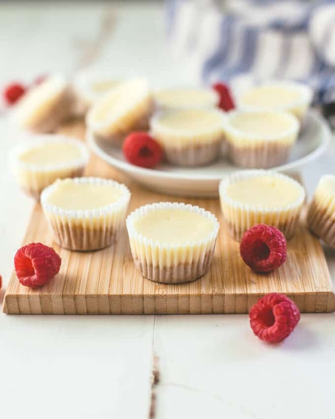 mini cheesecakes on a wooden cutting board