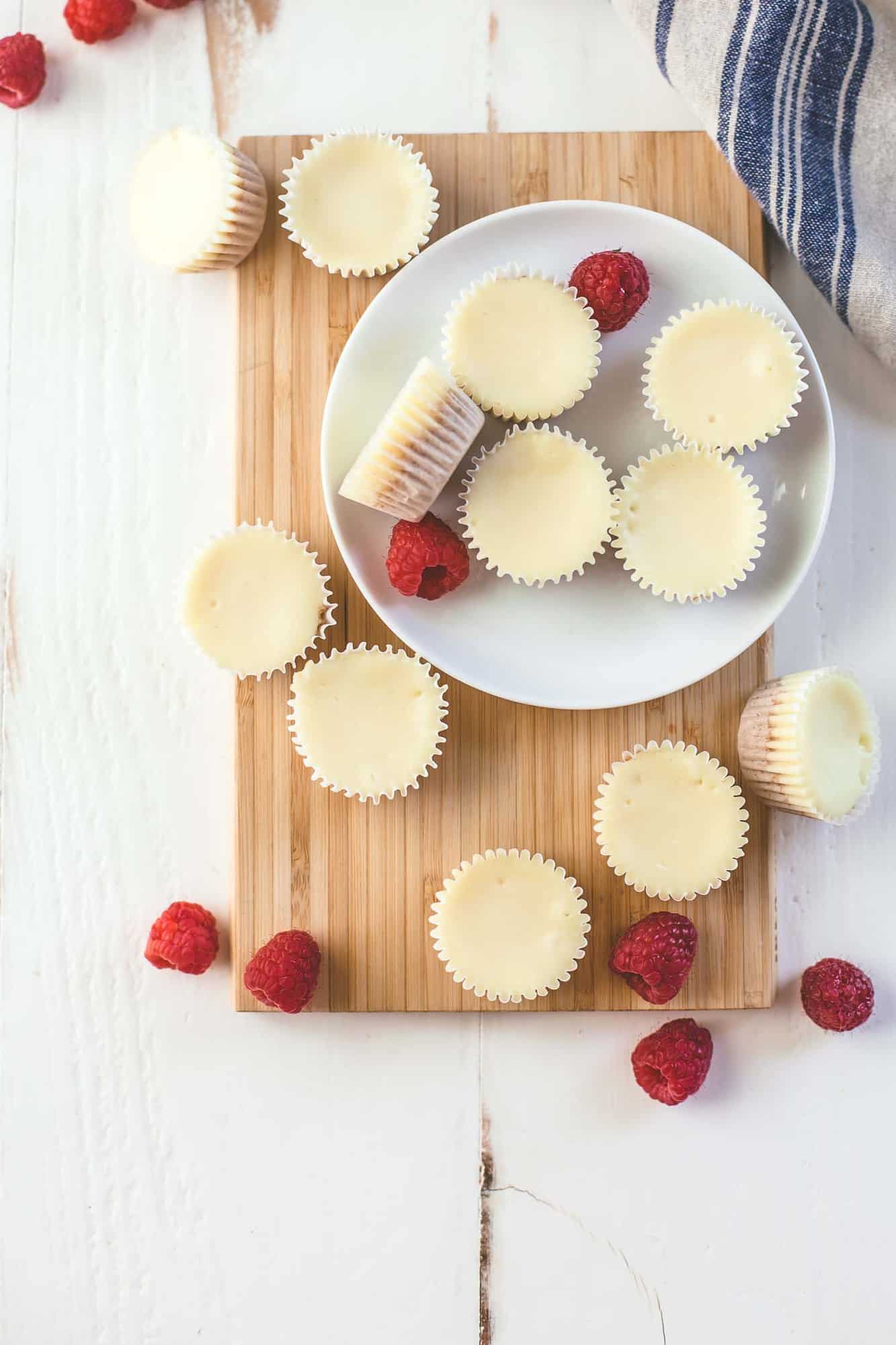 overhead image of mini cheesecakes on a white plate