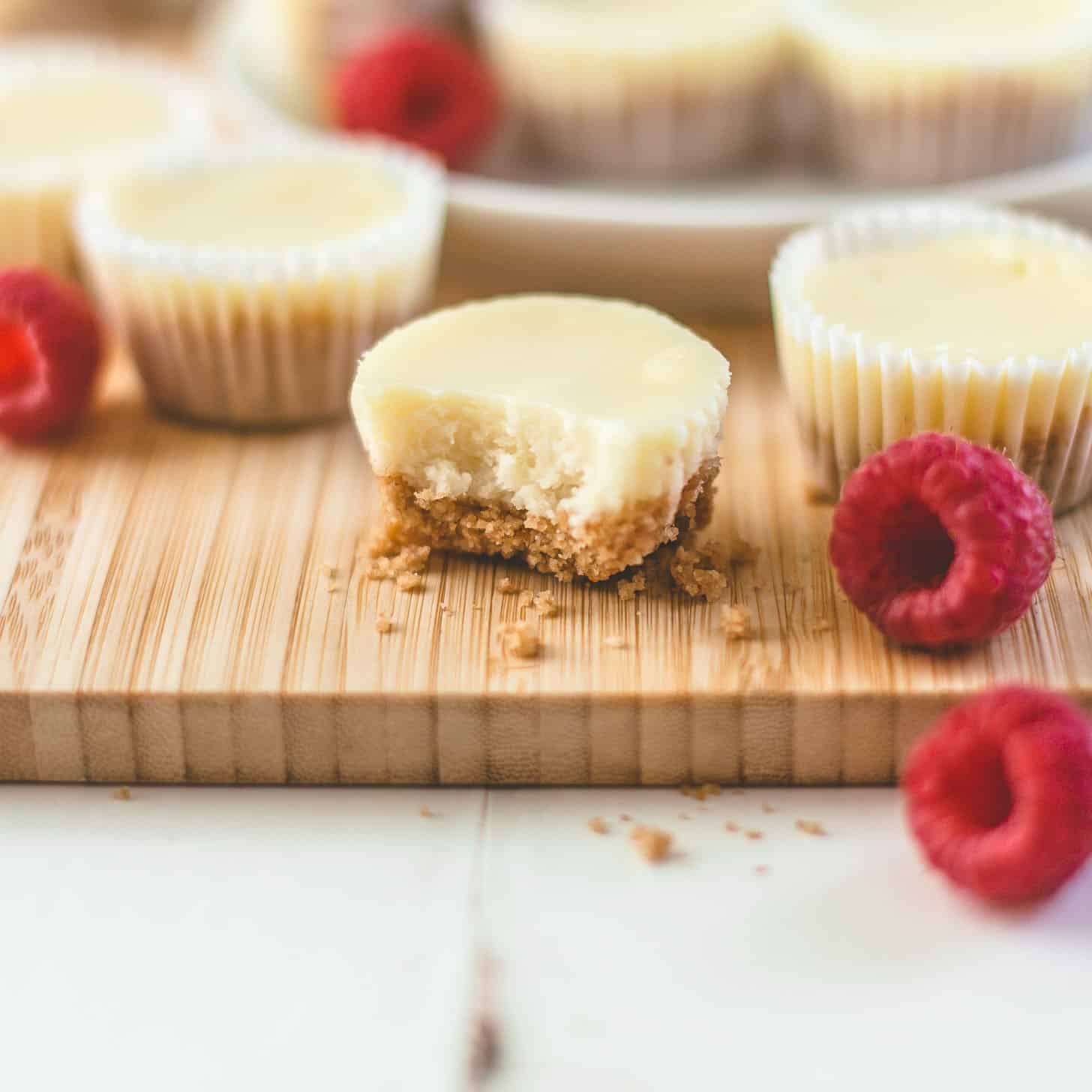 mini cheesecakes on a wood cutting board