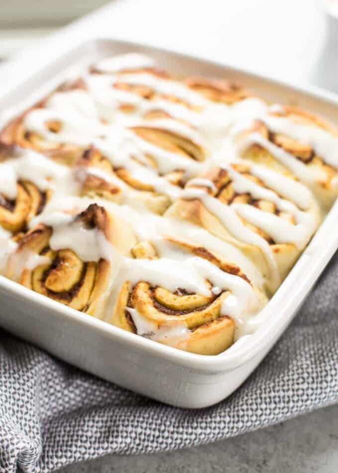 pumpkin cinnamon rolls in a white baking dish