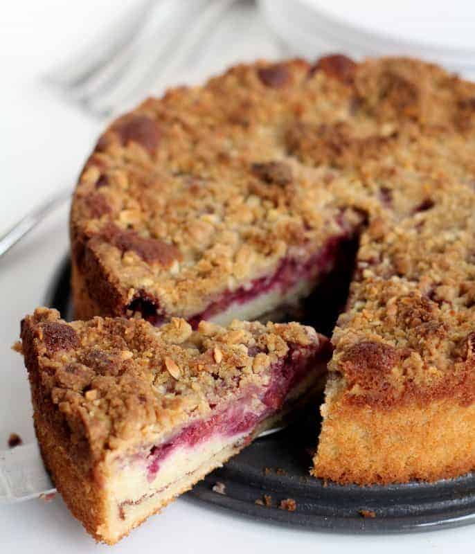 a slice of raspberry almond coffee cake on a round tray