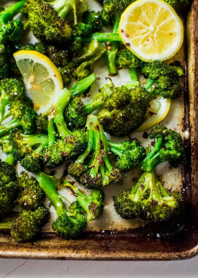 roasted broccoli and lemon slices on a sheet pan