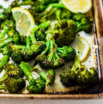 roasted broccoli and lemon slices on a sheet pan
