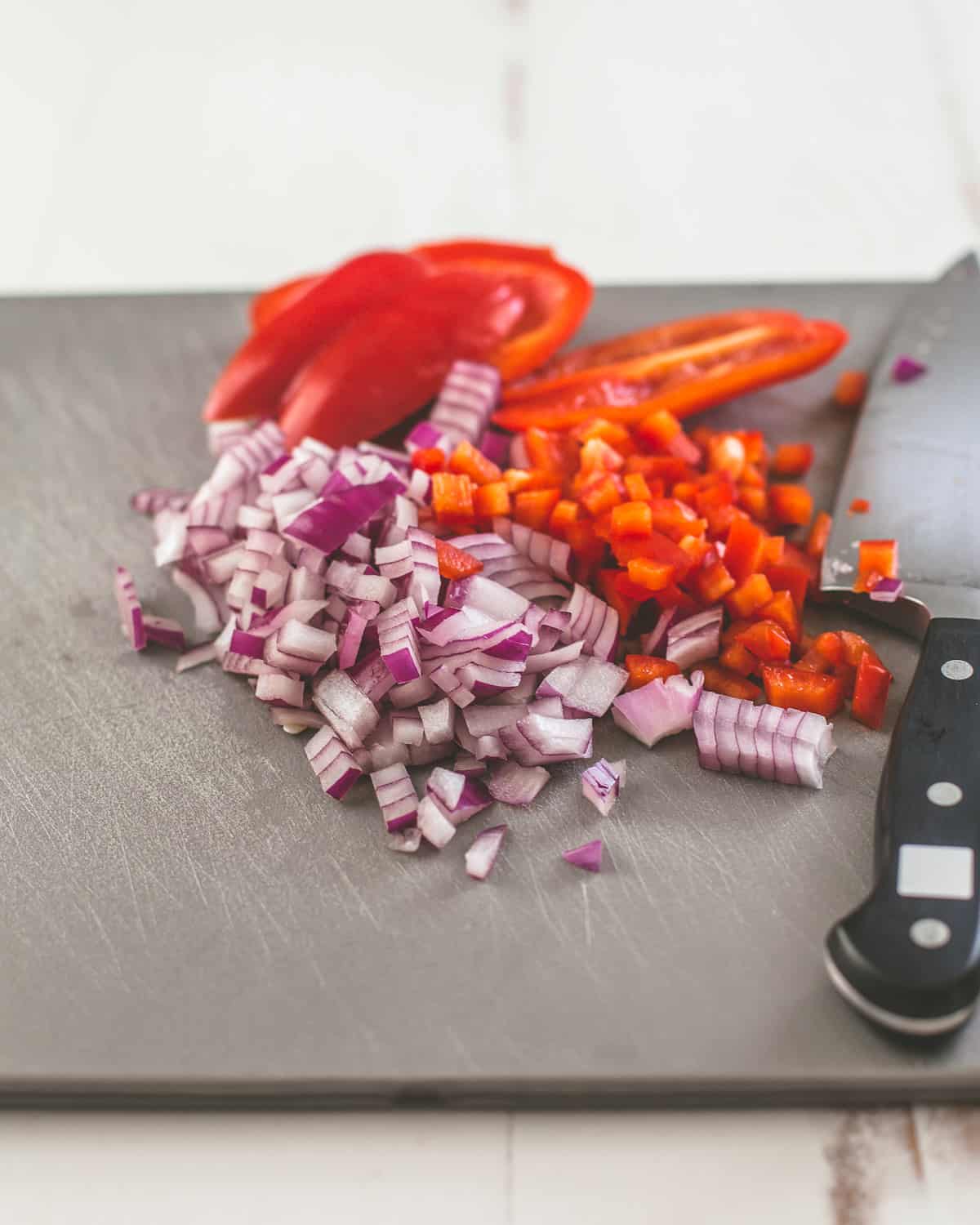 onions and peppers on a cutting board