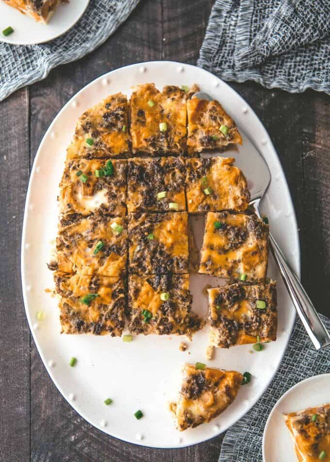 slow cooker sausage casserole on an oval white tray